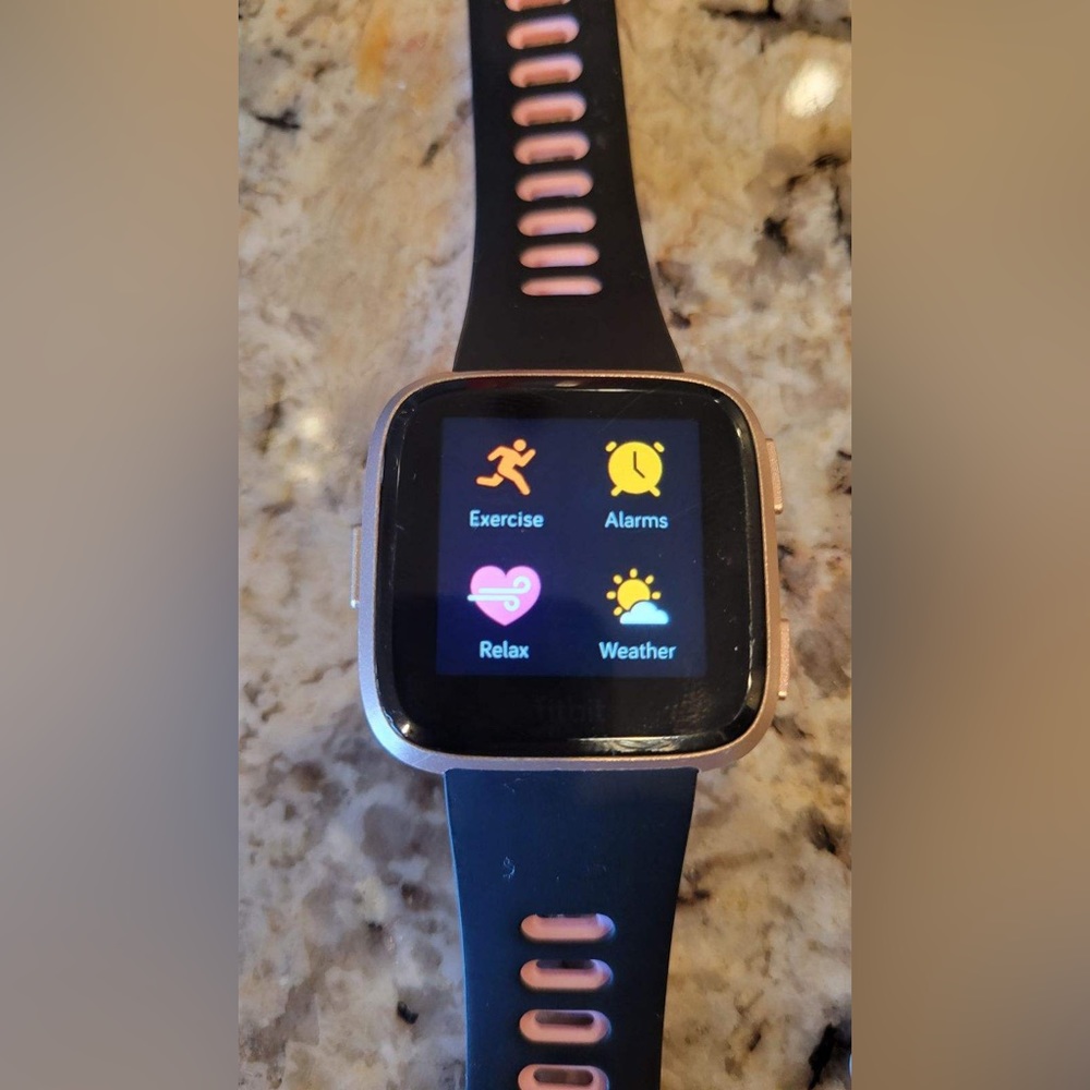 Veres Fitbit including charger and several watchbands. Updated software.